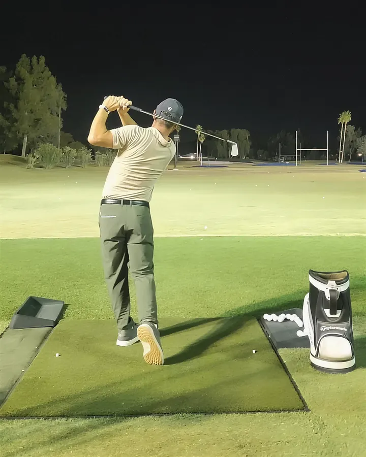 Pat at the top of his backswing on the floodlit range at Dobson Ranch